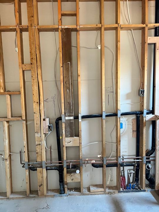 Bathroom wall opened for new plumbing