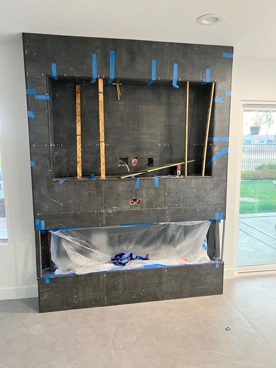 Fireplace and media wall tile going up