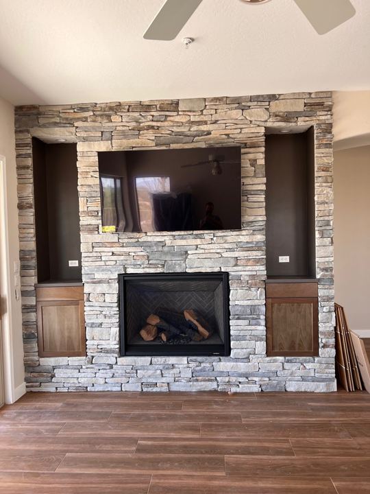 Stacked-stone fireplace with built-ins