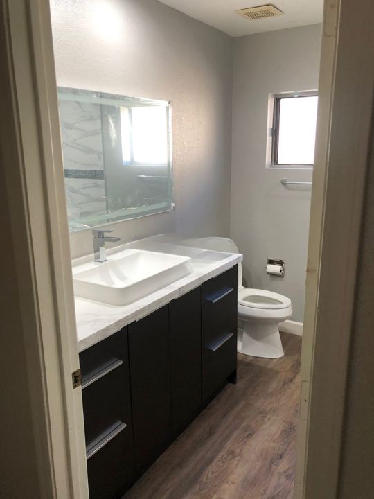 Black vanity with vessel sink