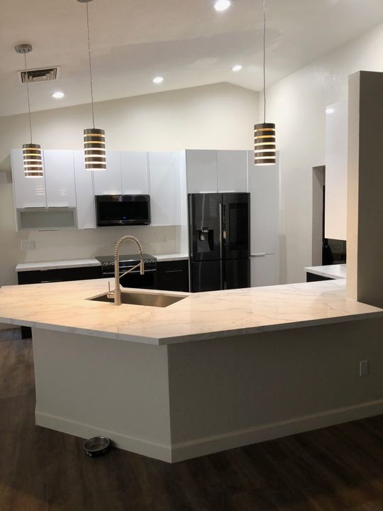 White and black kitchen with quartz peninsula