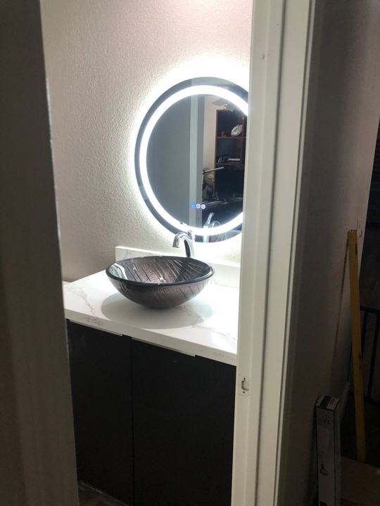 Vessel sink and round lighted mirror