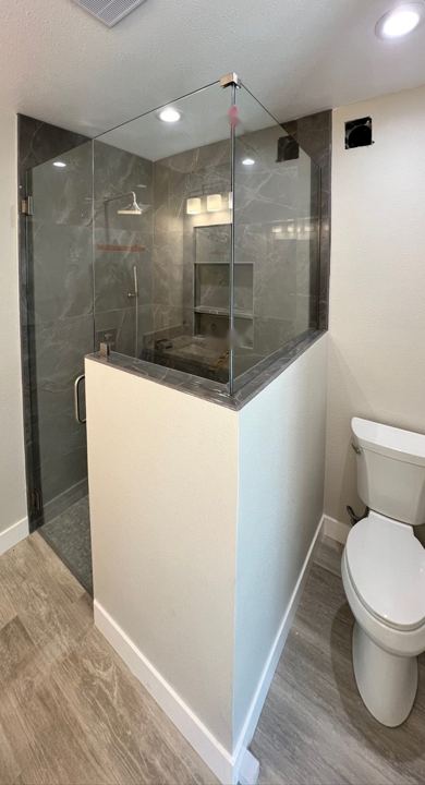 Tiled walk-in shower with glass