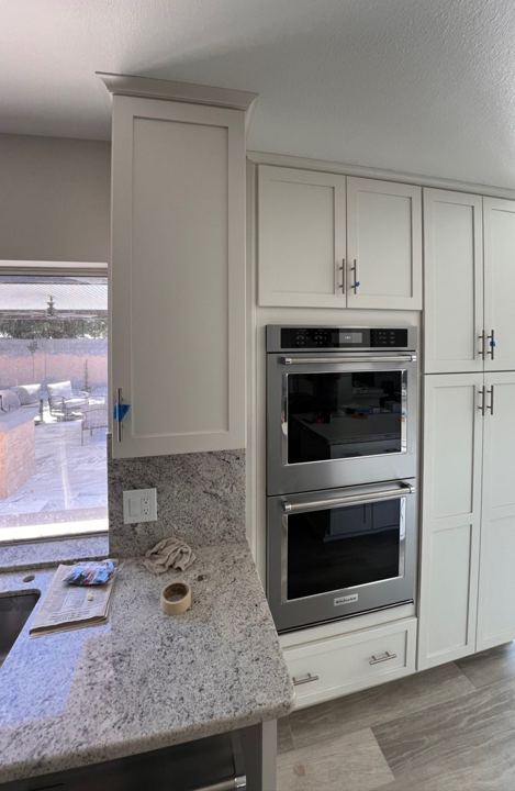 White shaker cabinets with wall ovens